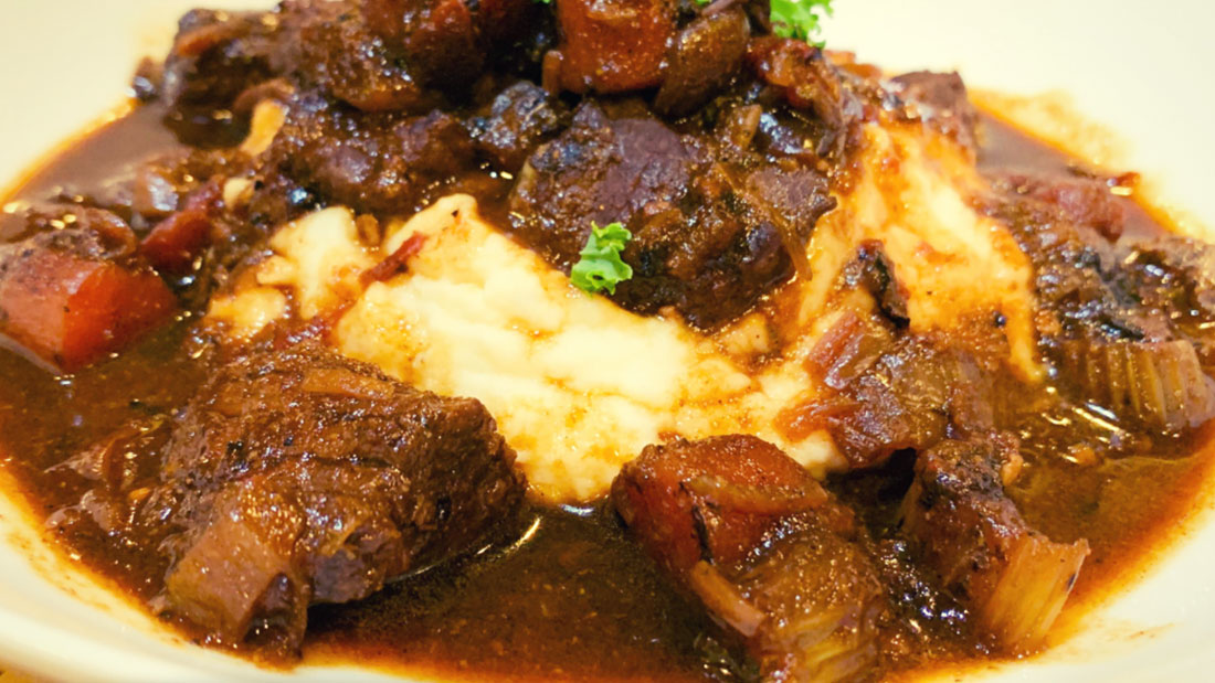 closeup of hearty beef stew with mashed potatoes